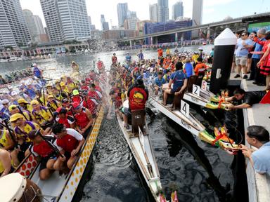 Paddlers churn the water as spectators watch the 12m long dragon boats battle it out.Originating in the rivers of Southe...