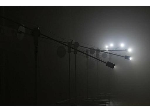 Eight kinetic sculptures cast rotating planes of light and sound throughout a darkened room, oscillating between order a...