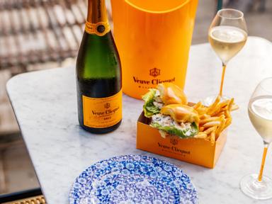Feel oh-so chic with a chilled bottle of Veuve Clicquot and a picnic box with lobster rolls and frites for $99 from Stan...